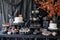 A spooky Halloween dessert table with themed treats and decorations Halloween cupcake