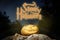 Spooky Halloween warm neon pumpkin in on a rock in the darkness