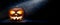 The spooky haunted evil glowing eyes of Jack O\' Lanterns, halloween pumpkin, on the left of a wooden bench