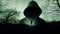 A spooky horror concept of a ghostly hooded figure silhouetted against a lonely figure in a scary winter forest. With a grunge