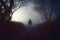 A spooky, horror concept. Of a scary shadow person with a hat standing in a country road.  With trees silhouetted against the fog