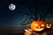 Spooky Jack O Lantern pumpkins under moon on Halloween. Space for text