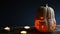 Spooky Jack-shaped pumpkin for Halloween with cut-out eyes, Windows and door and a flickering candle inside. Orange lantern for a