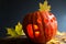 Spooky Jack-shaped pumpkin for Halloween with cut-out eyes, Windows and door and a flickering candle inside. Orange lantern for a