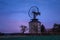 Spooky landscape with haunted wind mill at night. Moment after sunset. Windmill called Ruprechtov in Czech republic.