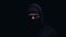 Spooky man in balaclava and hood looking into camera, member of gangster group