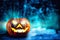 A spooky mystic forest at halloween night with a haunted evil glowing eyes of Jack O` Lanterns pumpkin copy space