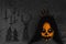 Spooky pumpkin face of a halloween creature on dark background with occult symbols