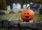 Spooky pumpkin with graveyard background