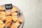 Spooky sausage mummies for Halloween party served on light grey table, top view.