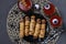 Spooky sausage mummies, tomato juice and sauce for Halloween party on dark background. Top view
