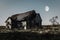 Spooky scene of haunted house and moon.Old mystic building at dead tree.Horror Halloween concept.Toned