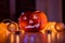 Spooky smiling halloween pumpkin in burning fire candles flames.
