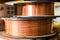 Spool of copper wire, bronze cable in reels at industry production