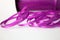 Spool of purple curling ribbon on a white background