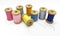 Spools of bright multi-colored threads on a white background