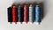 Spools of thread for machine sewing in different colors - red, pink, blue, gray, purple, blueberry, black