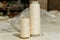 Spools of thread in  white are placed side by side on a white surface,