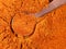 Spoon on chili powder from cayenne pepper closeup