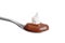 Spoon of chocolate pudding with whipped cream