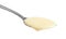 Spoon with condensed milk on white, closeup. Dairy product