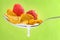 Spoon with corn flakes and raspberry