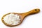 Spoon with cornstarch, flour made from corn used to make creams or as a thickener. White background, copy space