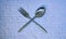 spoon and cutlery made of aluminum cross each other