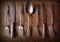 Spoon, forks, knives, ladles on a wooden table, selective focus and toned image. Top view