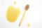 Spoon with fresh honey spilled on a white background. organic vitamin food