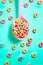 Spoon full of corn rings or cereals on pastel background. Ai generative