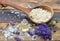 Spoon full of flakes of soap with essential oil and bunch of lavender flowers