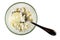 Spoon in glass bowl with cottage cheese poured condensed milk isolated on white. Top view