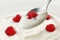 Spoon of greek yogurt with raspberry