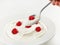 Spoon of greek yogurt with raspberry