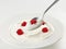 Spoon of greek yogurt with raspberry