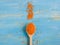 Spoon with healthy lentils on wooden blue background. Colorful and stylish composition. Vegetarian super food. Copy space