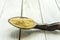 Spoon with Kava Kava root powder on wooden table closeup