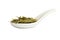 Spoon with long leaves green loose tea, isolated