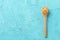 Spoon with peanut butter on color background, space for text