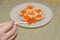 On the spoon is a red caviar in the background of a plate with sandwiches which is out of focus, horizontal