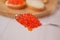 Spoon with red caviar. Close-up of salmon caviar. Tasty and healthy food. Delicatessen. Making sandwiches