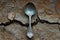 Spoon rests on cracked dirt alone in solitude telling a tale of scarcity and resilience in a desolate environment, global water