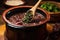 spoon scooping feijoada from a pot