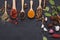 Spoon spices chili garlic salt kosher pepper set on a dark stone table. Top view with copy area