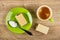 Spoon with sugar, wafer in saucer, coffee espresso in cup on table. Top view