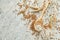 Spoon with wheat flour and grains on wooden background