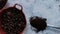 Spoonful of coffee and pots of coffee beans and anise seeds on white surface