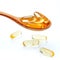 Spoonful of gel capsules of omega 3. Close up capsules fish oil