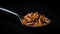 Spoonful of mealworms, edible snack insects isolated on black background. Mealworm larvae as food. Fried roasted worms. Animal